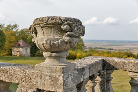 Pidhirtsi Castle terrace with stone vase and park landscape. It is a residential castle located in the village of Pidhirtsi in Lviv province, Western Ukraine.の写真素材