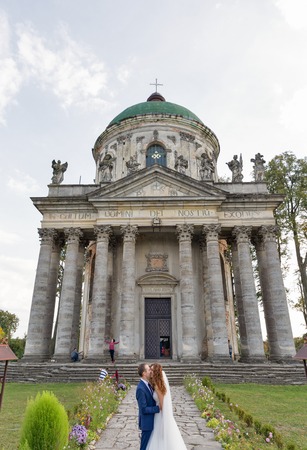 PIDHIRTSI, UKRAINE - OCTOBER 02, 2016: Wedding ceremony in front of baroque Roman Catholic church of St. Joseph. Pidhirtsi village is located in Lviv province, Western Ukraine.のeditorial素材