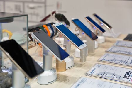 KIEV, UKRAINE - APRIL 07, 2017: Nomi mobile devices Chinese company booth at 2nd International Trade Show of Electric and Hybrid Vehicles Plug-In Ukraine in KyivExpoPlaza venue.のeditorial素材