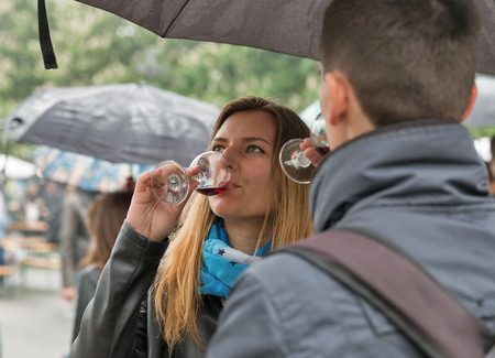 KIEV, UKRAINE - MAY 13, 2017: Unrecognized young people taste wine during Kyiv Food and Wine Festival in National Expocenter, a permanent multi-purpose exhibition complex in the Teremky neighborhood.のeditorial素材