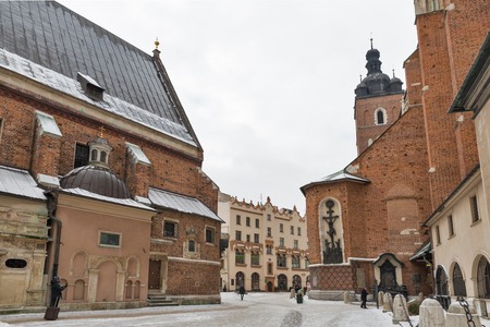 KRAKOW, POLAND - JANUARY 12, 2017: People walk along St. Mary gothic church and St Barbara church on Main Market square in old town. Krakow is the second largest and one of the oldest cities in Polandのeditorial素材