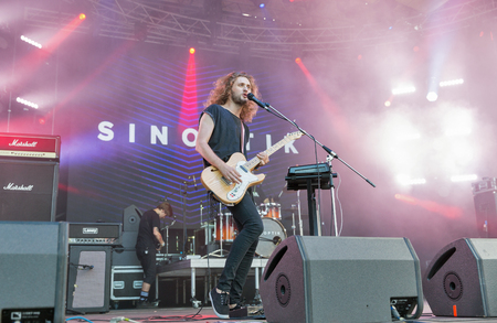 KIEV, UKRAINE - JULY 02, 2017: Rock band Sinoptik, winner Global Battle of the Bands 2016, and its frontman and guitarist Dmitriy Afanasyev performs live at the Atlas Weekend Festival in Expocenter.のeditorial素材