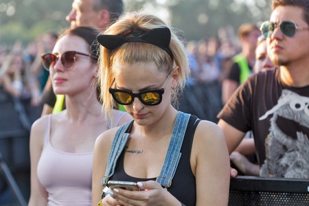 KIEV, UKRAINE - JUNE 29, 2017: Young fans visit music concert outdoors at the Atlas Weekend music...