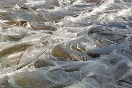 Abstract field covered by polyethylene. Ecology concept.