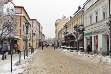 RZESZOW, POLAND - JANUARY 17, 2017: People walk along Tadeusz Kosciuszko winter street with shops and cafes. It is the largest city in southeastern Poland located on Wislok River in Sandomierz Basin.のeditorial素材