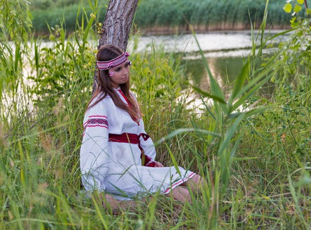 Beautiful young caucasian girl in national Ukrainian embroidery dress portrait. Holiday of Ivan...