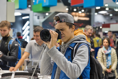 KIEV, UKRAINE - OCTOBER 07, 2017: People testing professional photographic cameras on Sony company booth during CEE 2017, the largest electronics trade show of Ukraine in KyivExpoPlaza EC.のeditorial素材