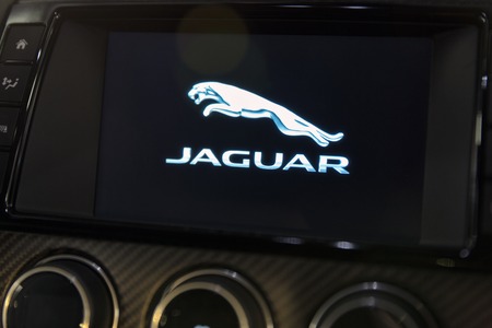 KIEV, UKRAINE - OCTOBER 27, 2017: Modern Jaguar F-TYPE car dashboard with logo closeup on the art...
