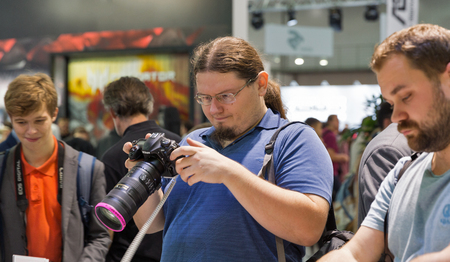 KIEV, UKRAINE - OCTOBER 07, 2017: Unrecognized visitors testing professional photographic cameras on Nikon booth during CEE 2017, the largest electronics trade show of Ukraine in KyivExpoPlaza EC.のeditorial素材