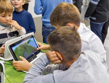 KIEV, UKRAINE - OCTOBER 07, 2017: Kids visit Microsoft, American multinational technology company booth during CEE 2017, the largest electronics trade show of Ukraine in KyivExpoPlaza EC.のeditorial素材