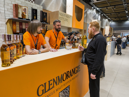 KIEV, UKRAINE - NOVEMBER 25, 2017: Unrecognized man visits Glenmorangie Single Malt Scotch Whisky Highland distillery booth at 3rd Ukrainian Whisky Dram Festival in Parkovy Exhibition Center.のeditorial素材