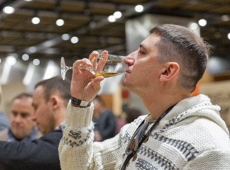 KIEV, UKRAINE - NOVEMBER 25, 2017: Unrecognized man tasting Single Malt Scotch Whisky at 3rd...