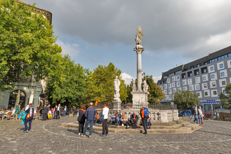 BRATISLAVA, SLOVAKIA - SEPTEMBER 25, 2017: Unrecognized tourists have a rest near Plague Column at Rybne Namestie ( Fish Square ) at sunny day in old town.のeditorial素材