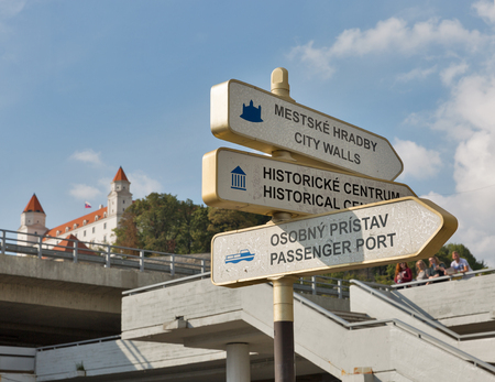 Info tourist pointer closeup in Bratislava old town, sign board with Castle, blue sky and clouds. Slovakia.の写真素材