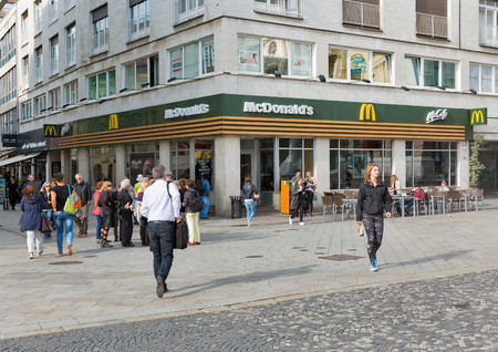 BRATISLAVA, SLOVAKIA - SEPTEMBER 25, 2017: People walk along McDonald's restaurant in Old Town. With a population of about 450 000, Bratislava is one of the smaller capitals of Europe.のeditorial素材