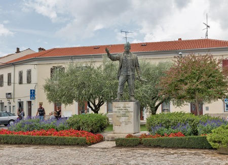 POREC, CROATIA - SEPTEMBER 21, 2017: People walk along Joakim Rakovac monument. Porec is a town almost 2,000 years old. Rakovac is a national hero in World War 2 fought against occupiers.のeditorial素材