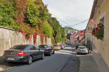 BANSKA STIAVNICA, SLOVAKIA - SEPTEMBER 27, 2017: Anton Pecha street with view over Calvary on the hill. It is a completely preserved medieval town in central Slovakia, UNESCO World Heritage Site.のeditorial素材
