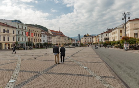 BANSKA BYSTRICA, SLOVAKIA - SEPTEMBER 29, 2017: People walk along central SNP square with fountain...