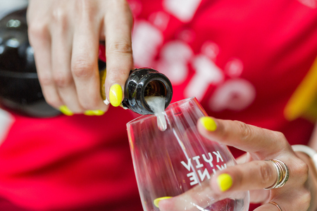 KIEV, UKRAINE - JUNE 02, 2018: Pouring sparkling wine closeup at Kyiv Wine Festival. 77 winemakers from around the world took part in the big festival organized by Good Wine company.のeditorial素材