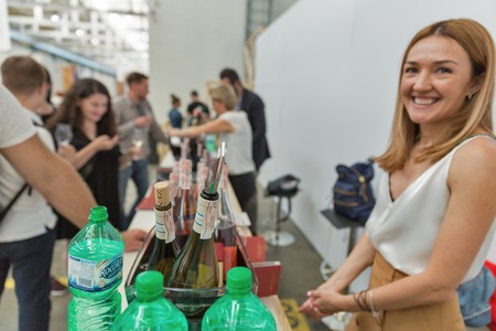 KIEV, UKRAINE - JUNE 02, 2018: Woman sommelier presents its wines at Kyiv Wine Festival booth. 77 winemakers from around the world took part in the big festival organized by Good Wine company.のeditorial素材