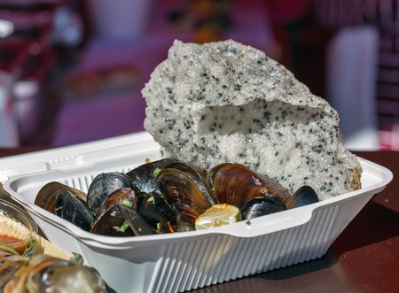 Fast food cooked mussels with rice chips with black sesame closeupの写真素材