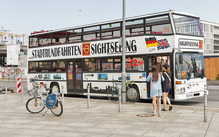 BERLIN, GERMANY - JULY 13, 2018: Tourists visit Berlin Stadtrundfahrten sightseeing bus in front of the central passenger railway station Hauptbahnhof.のeditorial素材