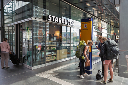 BERLIN, GERMANY - JULY 13, 2018: Unrecognized people visit Starbucks coffee house on Central Passenger Railway Station or Hauptbahnhof.のeditorial素材