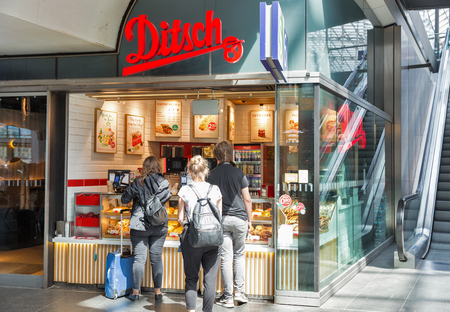 BERLIN, GERMANY - JULY 13, 2018: Unrecognized people buy pastries in Ditsch Traditional Bakery stall on Central Passenger Railway Station or Hauptbahnhof.のeditorial素材