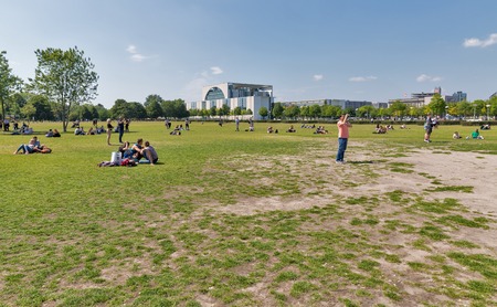 BERLIN, GERMANY - JULY 13, 2018: People relaxing on the grass in National park on Republic Square in...