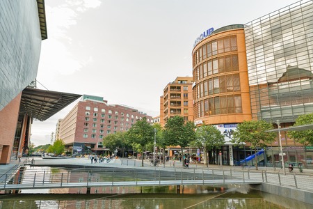 BERLIN, GERMANY - JULY 13, 2018: People walk at Marlene Dietrich Platz with Stage Theater at Potsdamer Platz and Stage Theater Bluemax. Berlin is the capital and largest city of Germany.のeditorial素材