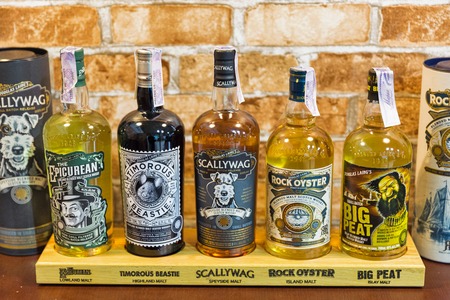 KIEV, UKRAINE - OCTOBER 20, 2018: Irish independent bottlers blended malt whisky bottles in a row at booth of 4th Ukrainian Whisky Dram Festival by Good Wine company in Artistic Arsenal.のeditorial素材