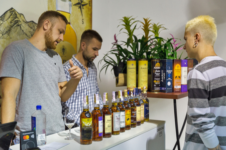 KIEV, UKRAINE - OCTOBER 20, 2018: People visit Amrut Indian single malt whisky booth at 4th Ukrainian Whisky Dram Festival organized by Good Wine company in Artistic Arsenal.のeditorial素材