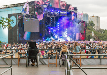 KIEV, UKRAINE - JULY 04, 2018: People enjoy live concert at special place for disabled at the Atlas Weekend Festival in National Expocenter.のeditorial素材