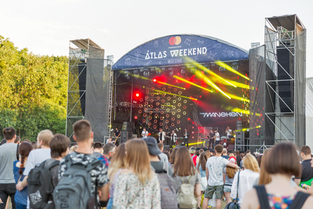 KIEV, UKRAINE - JULY 06, 2018: Young fans crowd enjoy The Maneken, Ukrainian pop and rock band live performance at the Atlas Weekend Festival in National Expocenter.のeditorial素材