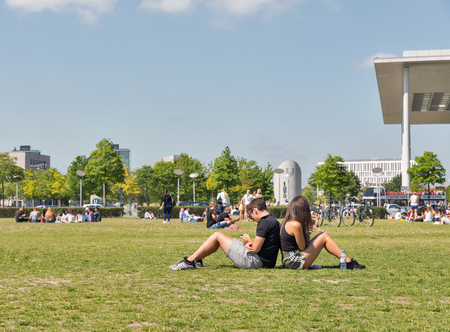 BERLIN, GERMANY - JULY 14,2018: Young people have a rest in front of Bundestag and Paul Lobe buildings on summer meadow. Berlin is the capital and German largest city by both area and population.のeditorial素材