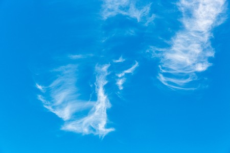 blue sky and fluffy clouds backgroundの写真素材