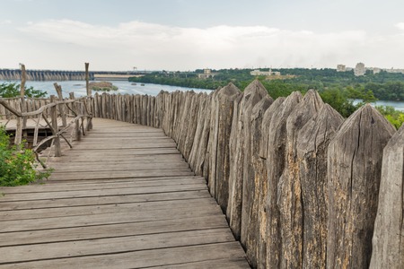 Medieval defensive wooden stockade walls on Cossacks Zaporozhskaya Sich on island of Khortytsia in...