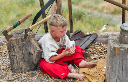 KHORTYTSIA, UKRAINE - JULY 03, 2018: Young boy Ukrainian Cossack in Zaporozhian Sich. It was inhabited by Cossacks who lived beyond the rapids of the Dnieper River in the 15th-18th century.のeditorial素材