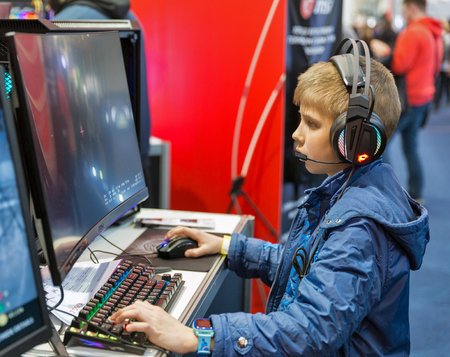 KYIV, UKRAINE - APRIL 06, 2019: Young boy visit MSI, a Taiwan based information technology corporation booth during CEE 2019, the largest electronics trade show of Ukraine in Tetra Pack EC.のeditorial素材