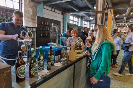 KYIV, UKRAINE - MAY 20, 2018: People enjoy craft beer during Kyiv Beer Festival vol. 3 in Art Zavod Platforma. About 300 unique varieties of craft beer were presented here.のeditorial素材