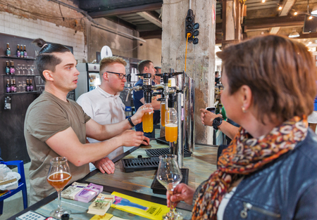 KYIV, UKRAINE - MAY 20, 2018: People enjoy craft beer during Kyiv Beer Festival vol. 3 in Art Zavod Platforma. About 300 unique varieties of craft beer were presented here.のeditorial素材
