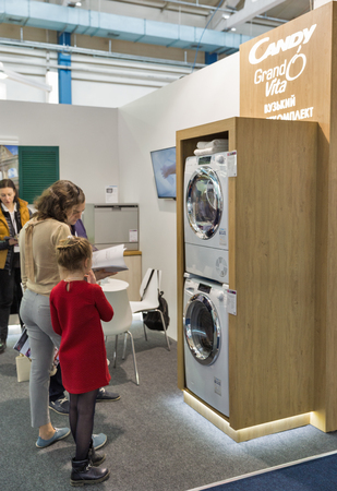 KYIV, UKRAINE - APRIL 06, 2019: Unrecognized people visit Candy, a large family owned Italian company booth during CEE 2019, the largest electronics trade show of Ukraine in Tetra Pak EC.のeditorial素材