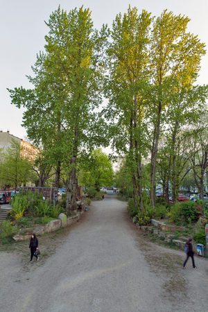 BERLIN, GERMANY - APRIL 18, 2019: People walk in a park in front of Oranienplatz or Orange Square at spring. Berlin is the capital and largest city of Germany by both area and population.のeditorial素材