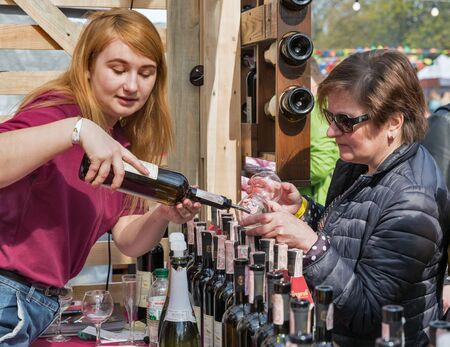 KYIV, UKRAINE - APRIL 21, 2019: People visit Bugeuli Georgian winery booth during Food and Wine Festival in National Expocenter, a permanent multi-purpose exhibition complex.のeditorial素材