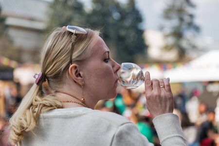 KYIV, UKRAINE - APRIL 21, 2019: People tasting wine during Food and Wine Festival in National Expocenter, a permanent multi-purpose exhibition complex.のeditorial素材