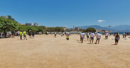 AJACCIO, CORSICA, FRANCE - JULY 13, 2019: Unrecognized players playing bocce ball on the beach. Bocce is a ball sport belonging to the boules family, closely to British bowls and French petanque.のeditorial素材