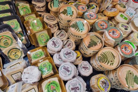 ALERIA, CORSICA, FRANCE - JULY 17, 2019: Different French cheese on counter in E.Leclerc supermarket. Corsica is located southeast of the French mainland and west of the Italian Peninsula.のeditorial素材