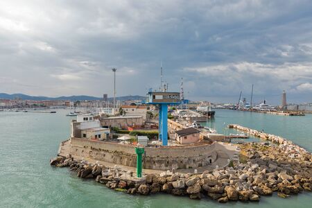 LIVORNO, ITALY - JULY 12, 2019: Cityscape with lighthouse and entrance to port at dawn. The Port of Livorno is one of the largest seaports both in Italy and the Mediterranean Sea.のeditorial素材