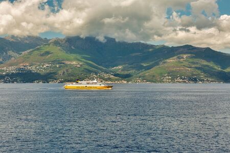 CORSICA, FRANCE - JULY 12, 2019: Corsica Ferries - Sardinia Ferries ship sailing in the sea with dramatic clouds. It is a ferry company that operates traffic to and from Corsica, Sardinia and Elba.のeditorial素材