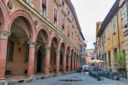 BOLOGNA, ITALY - JULY 10, 2019: People walk along Bolognini Amorini Salina Palace on Santo Stefano street in city historic center. Palace is notable by its circular niches with busts on the facade.のeditorial素材